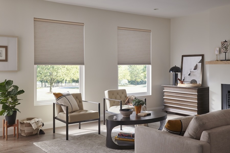 A living room with Lutron automated shades drawn halfway down the windows.